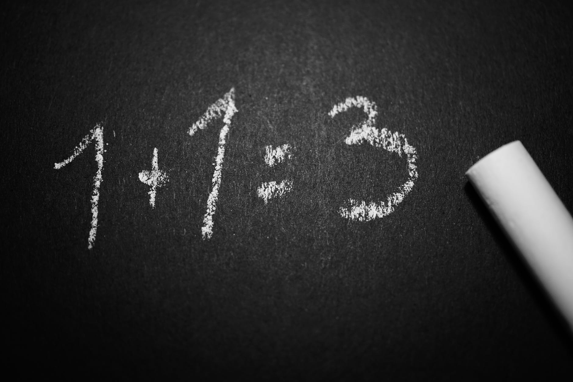 A chalkboard with the numbers 1 plus 1 equals 3.