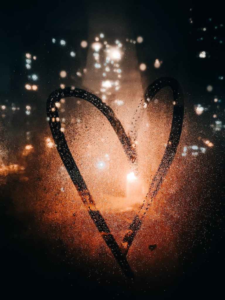 A heart with lots of sparkly lights around it.