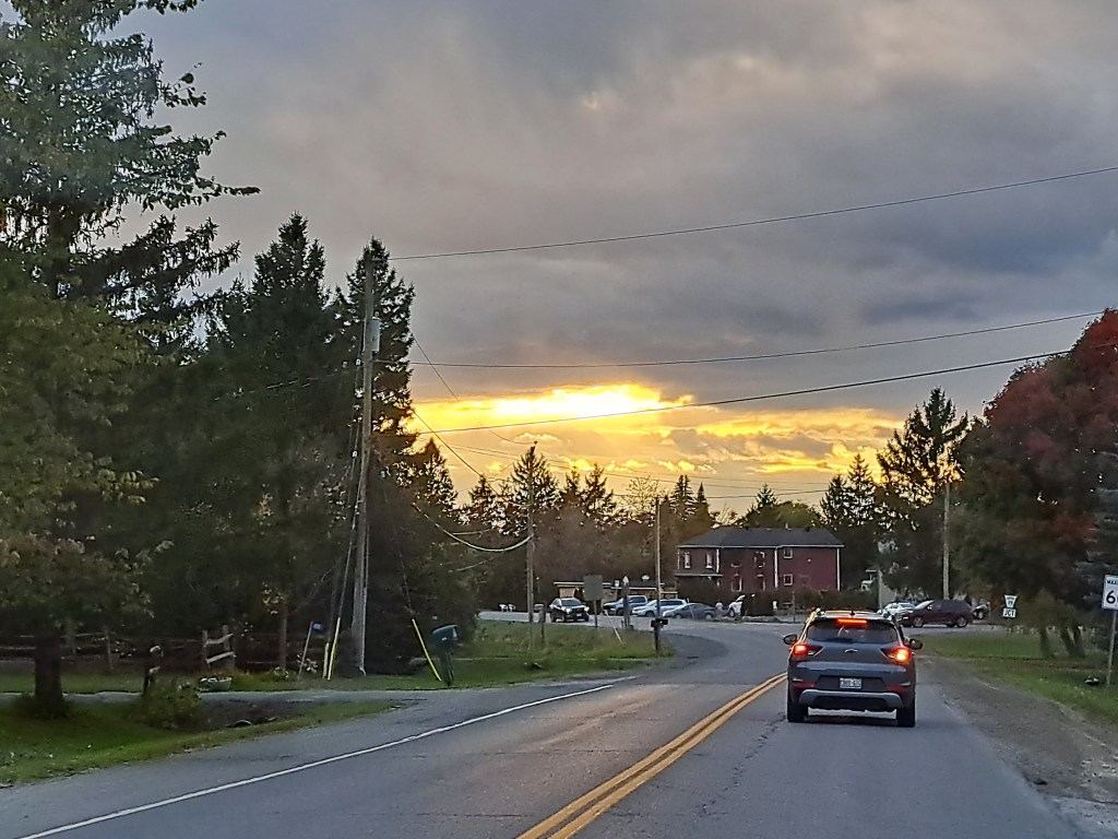 A country road with a beautiful sunset in the background 