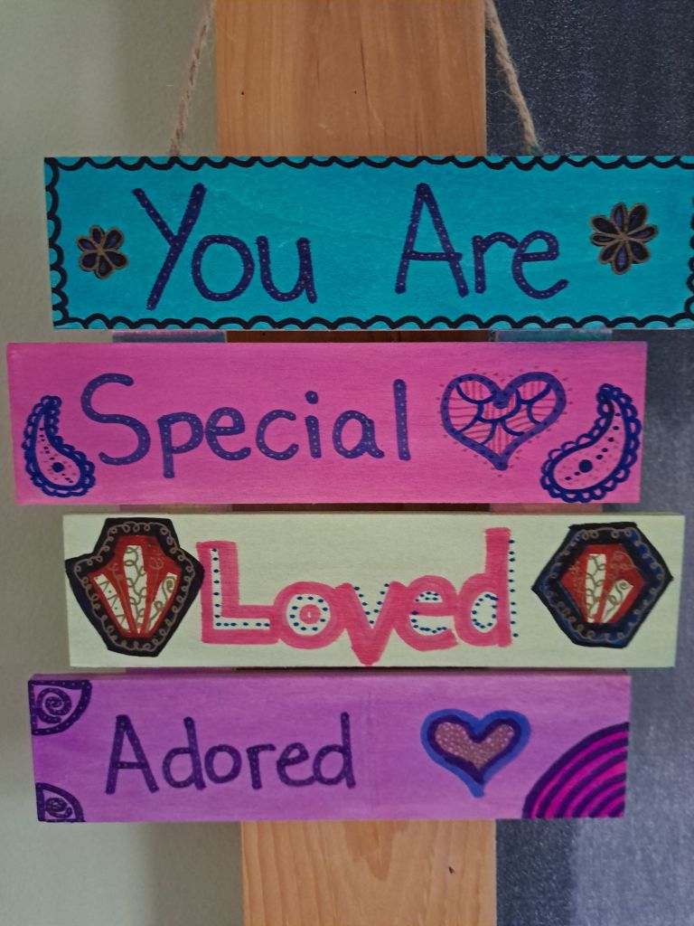 Wood art with the words, "you are special, loved, adored."