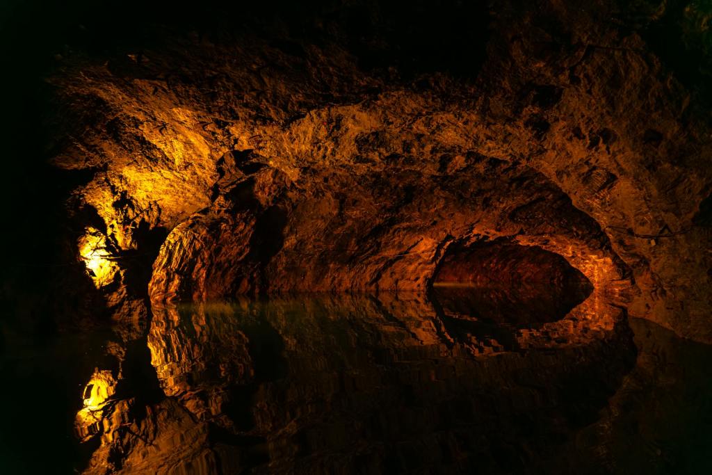 An underwater body of water with a cave at the far end